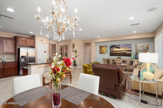 dining room featuring light tile patterned flooring and a chandelier