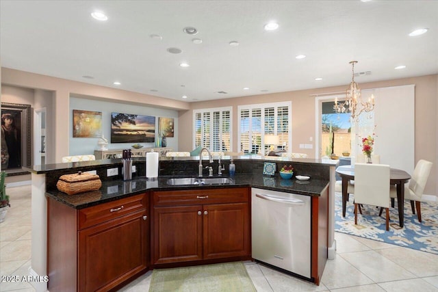 kitchen featuring pendant lighting, an island with sink, dishwasher, and sink