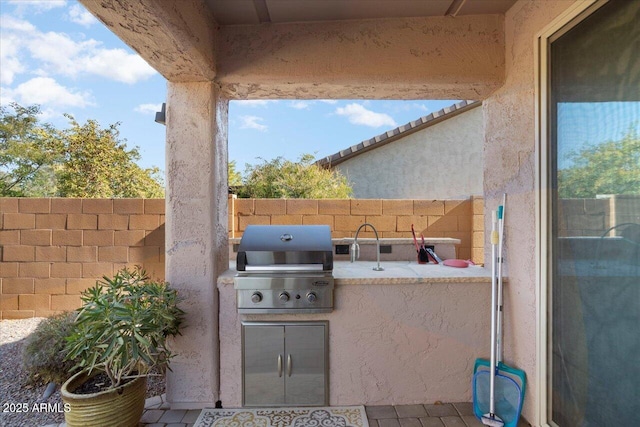 view of patio / terrace with area for grilling and an outdoor kitchen