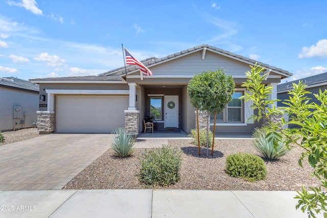 22634 E Roundup Way, Queen Creek, AZ 85142 - view of front of home featuring decorative driveway, an attached garage, a tile roof, stone siding, and stucco siding
