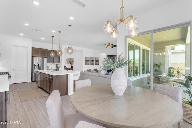 22634 E Roundup Way, Queen Creek, AZ 85142 - dining room with a ceiling fan, a chandelier, recessed lighting, and light wood-type flooring