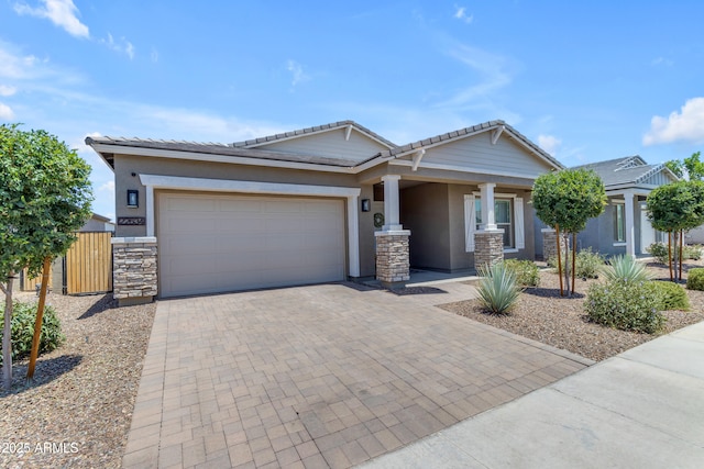 22634 E Roundup Way, Queen Creek, AZ 85142 - craftsman-style house featuring stucco siding, decorative driveway, a garage, stone siding, and a tiled roof