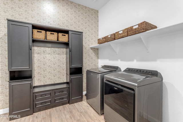 22634 E Roundup Way, Queen Creek, AZ 85142 - washroom with washer and clothes dryer, wallpapered walls, light wood-style floors, and cabinet space