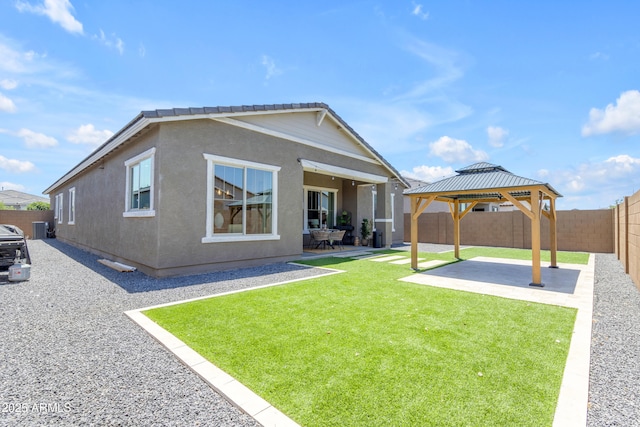 22634 E Roundup Way, Queen Creek, AZ 85142 - rear view of property featuring a patio area, a gazebo, a fenced backyard, and stucco siding