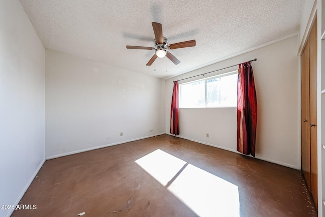 spare room featuring ceiling fan and a textured ceiling