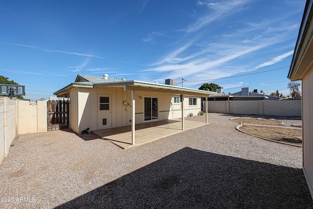 back of property with a patio