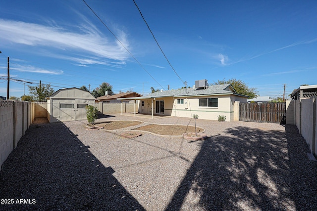 rear view of property featuring a shed, central AC, and a patio