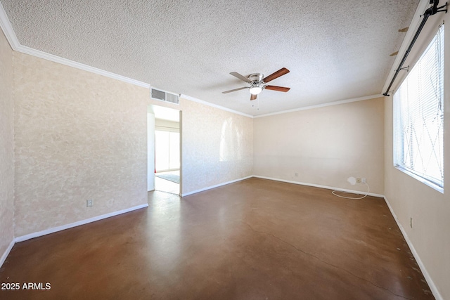 empty room featuring ceiling fan, ornamental molding, and a textured ceiling