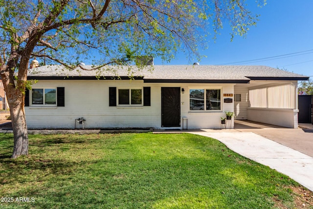 single story home with brick siding, a shingled roof, concrete driveway, a front yard, and a carport