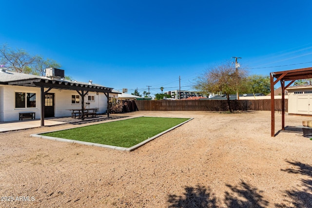 view of yard with a fenced backyard, central AC unit, a pergola, and a patio