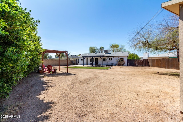 back of property featuring a patio, a fenced backyard, and a pergola