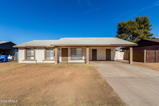 ranch-style house featuring a carport