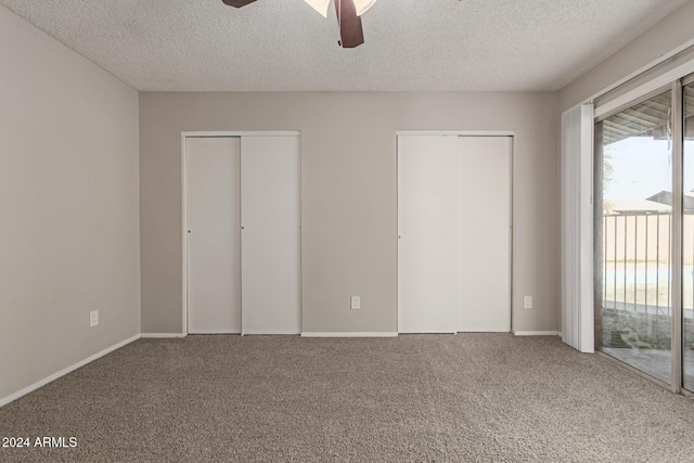 unfurnished bedroom with carpet flooring, a textured ceiling, access to outside, and ceiling fan