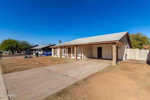 ranch-style home featuring a carport