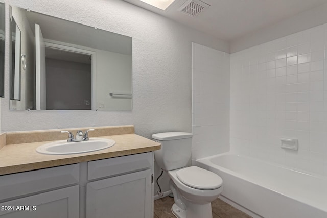 full bathroom with bathing tub / shower combination, tile patterned floors, vanity, and toilet