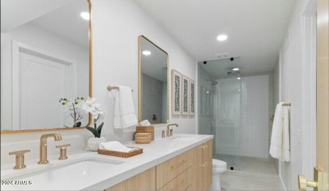 bathroom featuring vanity, toilet, and an enclosed shower