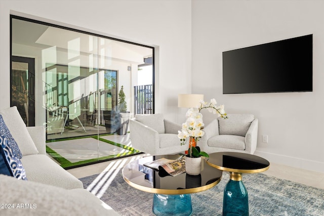 living room featuring tile patterned flooring and golf simulator