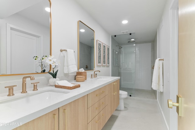 bathroom featuring vanity, toilet, and a shower with door