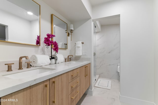 bathroom with a tile shower and vanity