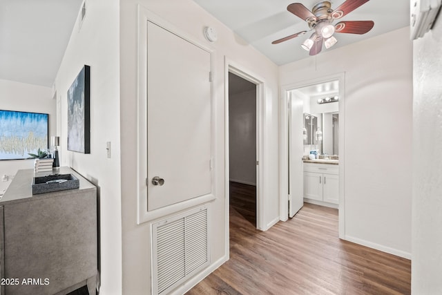 930 N Mesa Dr Unit 1079, Mesa, AZ 85201 - hall with baseboards, light wood finished floors, visible vents, and a wall mounted air conditioner
