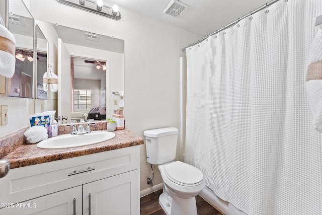 930 N Mesa Dr Unit 1079, Mesa, AZ 85201 - bathroom with toilet, wood finished floors, vanity, curtained shower, and visible vents