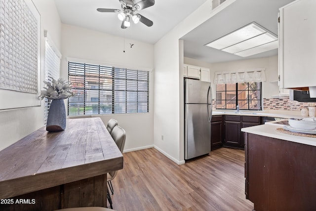 930 N Mesa Dr Unit 1079, Mesa, AZ 85201 - kitchen featuring light wood finished floors, freestanding refrigerator, visible vents, ceiling fan, and light countertops