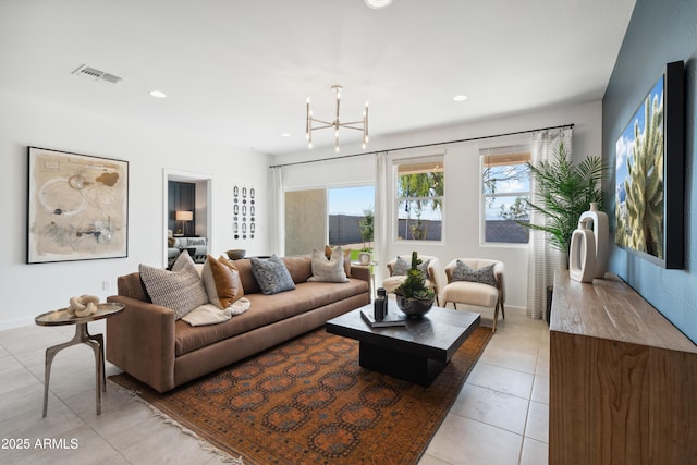 living room featuring light tile patterned floors and an inviting chandelier