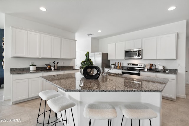 kitchen featuring white cabinetry, stainless steel appliances, and sink