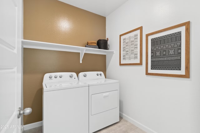 laundry room featuring light tile patterned flooring and washer and dryer