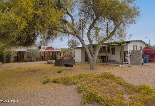 rear view of property featuring a fenced backyard