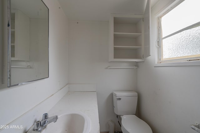 half bathroom featuring a sink and toilet