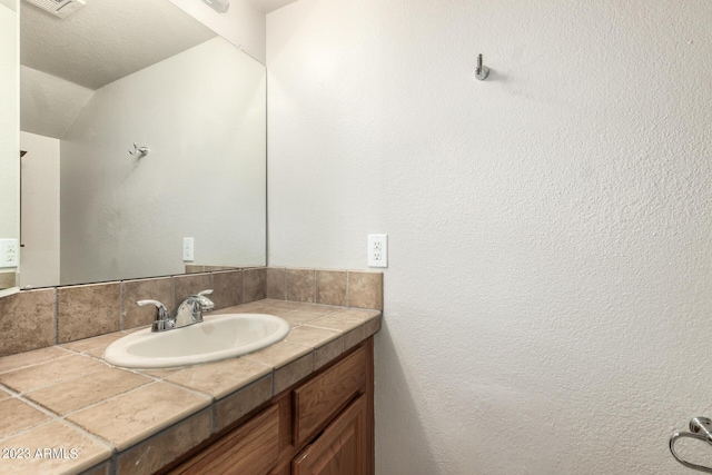 bathroom featuring backsplash and vanity