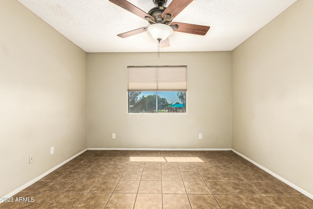 unfurnished room featuring ceiling fan, tile patterned floors, and a textured ceiling