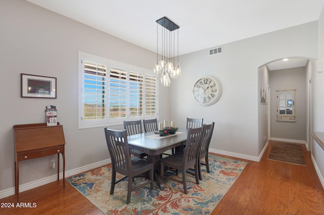 dining room with an inviting chandelier and hardwood / wood-style flooring