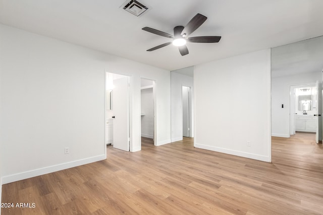 unfurnished bedroom featuring light hardwood / wood-style flooring and connected bathroom