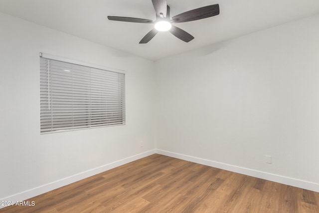 unfurnished room with ceiling fan and hardwood / wood-style flooring