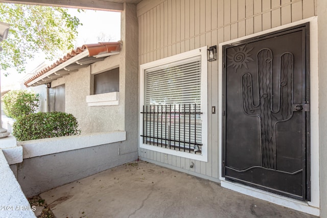 view of exterior entry featuring a patio area