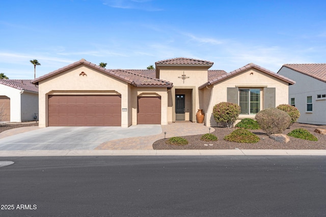 mediterranean / spanish-style home with a garage