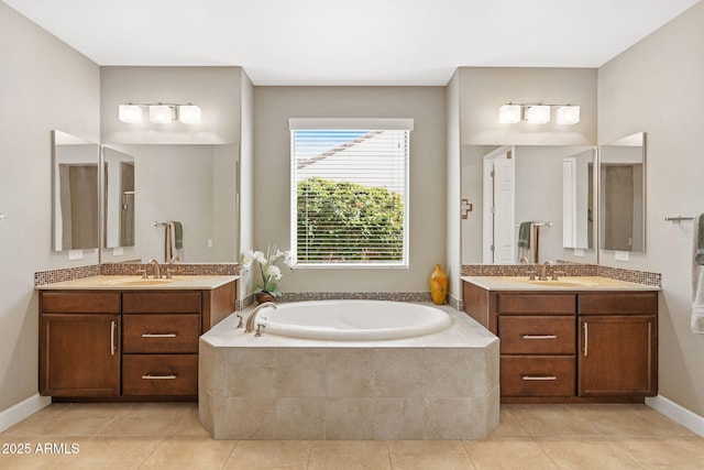 bathroom featuring a relaxing tiled tub, vanity, and tile patterned flooring