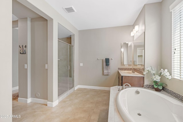 bathroom featuring independent shower and bath, vanity, and tile patterned flooring