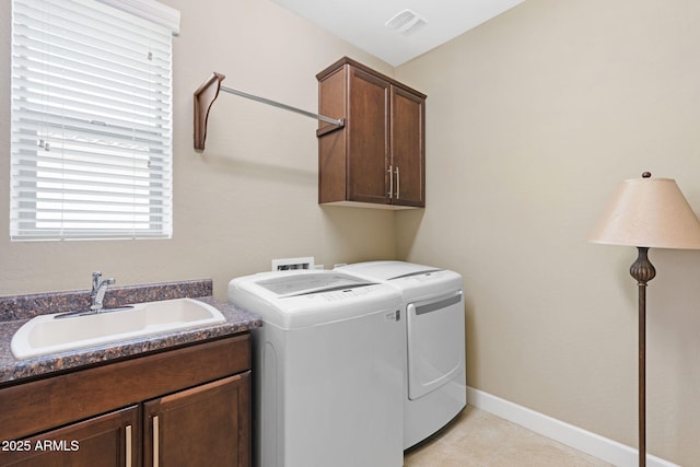 laundry room with cabinets, sink, and washing machine and clothes dryer