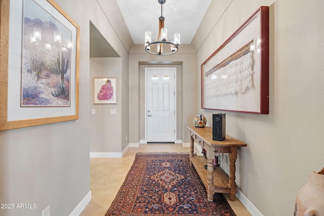 foyer entrance with light tile patterned flooring and a notable chandelier