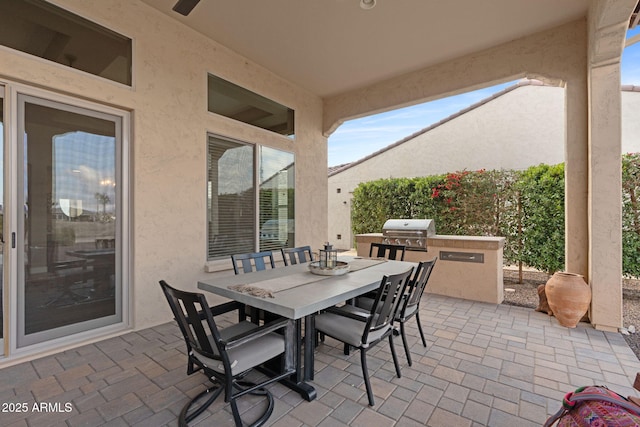 view of patio with area for grilling and a grill