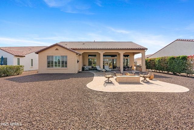 back of property featuring a patio and an outdoor fire pit