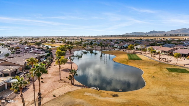 birds eye view of property with a water and mountain view