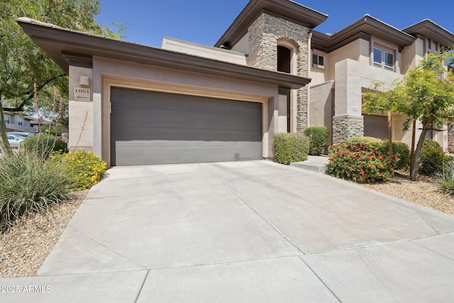 20121 N 76th St Unit 2061, Scottsdale, AZ 85255 - view of front facade featuring stucco siding, driveway, stone siding, and a garage