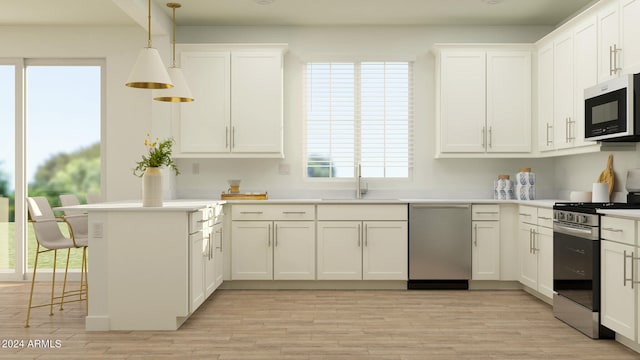 kitchen with white cabinetry, sink, hanging light fixtures, and appliances with stainless steel finishes