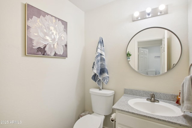 bathroom with toilet and vanity