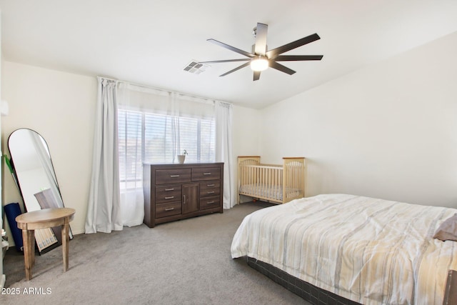 bedroom with ceiling fan and light carpet