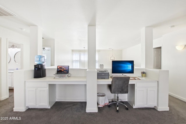 carpeted office featuring built in desk